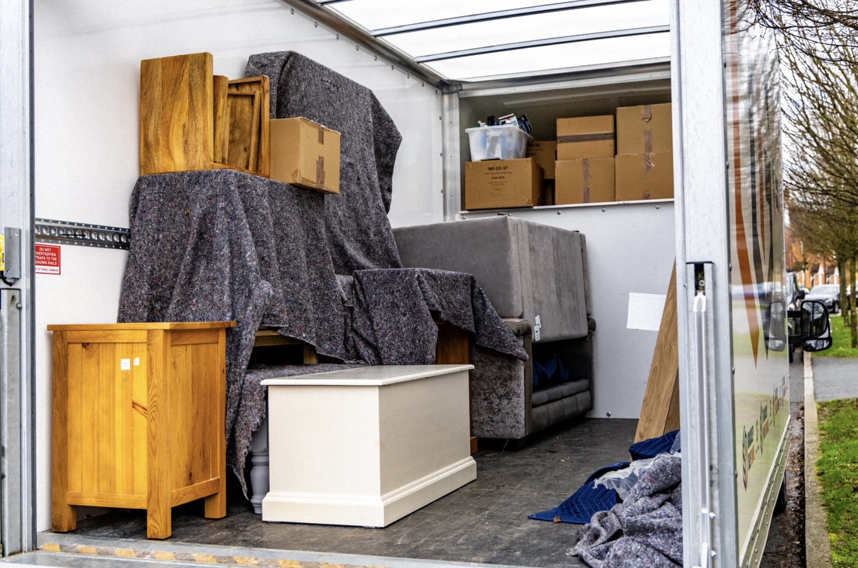 Boxes stacked in the back of a courier van