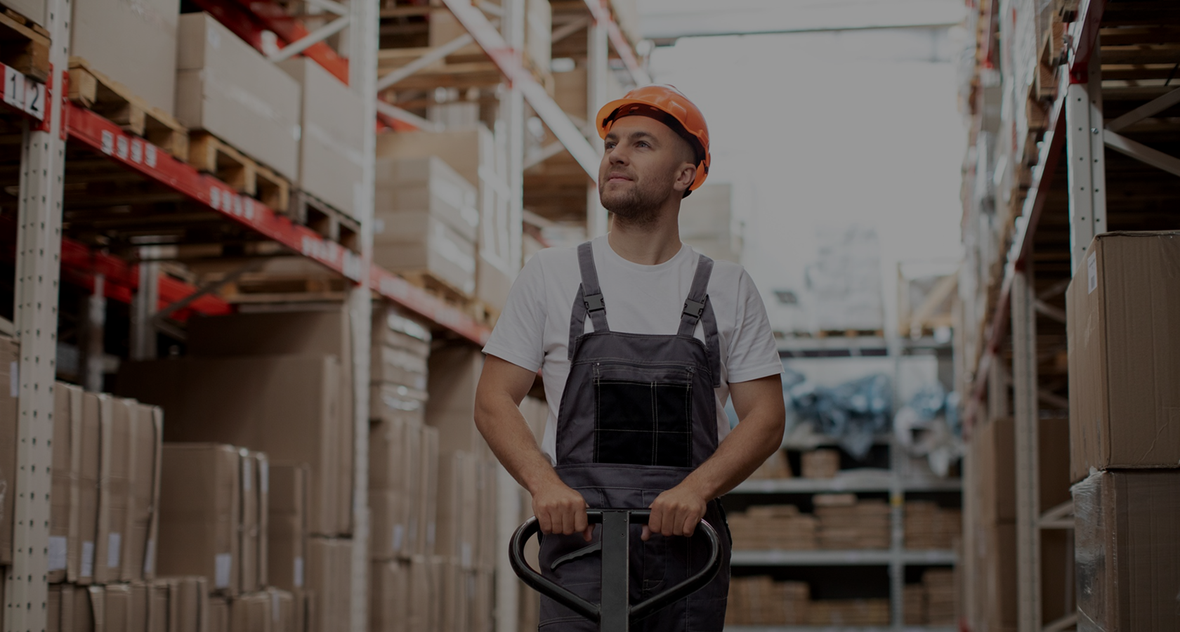 Warehouse worker moving goods with a pallet truck