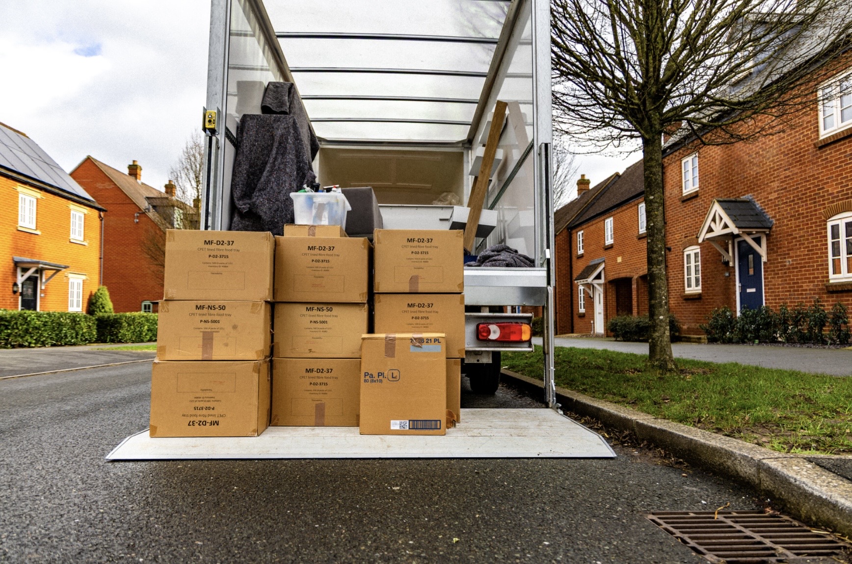 Parcels loaded on the tail lift of a delivery van in Brackley